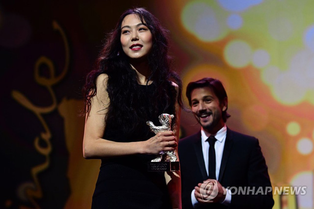 South Korean actress Kim Min-hee receives the Silver Bear award for best actress from Mexican director Diego Luna of the awards ceremony of the 67th Berlinale film festival in Berlin on February 18, 2017