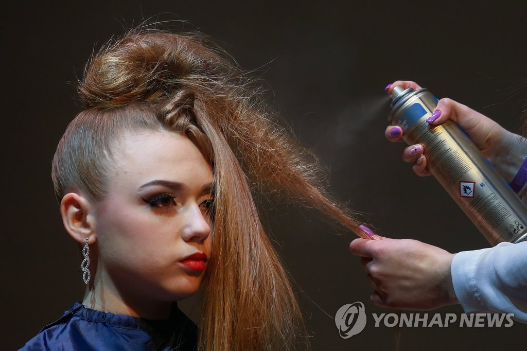 epa05921340 A model gets her make-up done during the annual hairdressers festival 'Crystal Angel' in Kiev, Ukraine, 22 April 2017. The best hairdressers and make-up artists participated in the international festival which takes place from 21 to 22 April. EPA/SERGEY DOLZHENKO