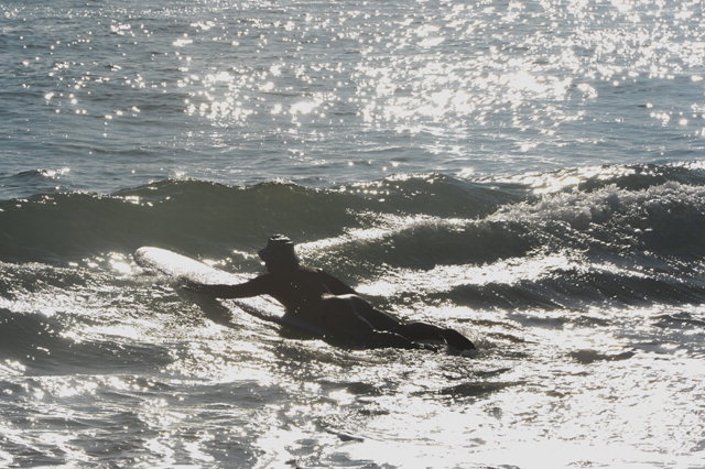 ▲ 겨울 서핑장비를 착용한 서퍼가 파도를 잡기위해 바다로 나가고 있다.  정일구