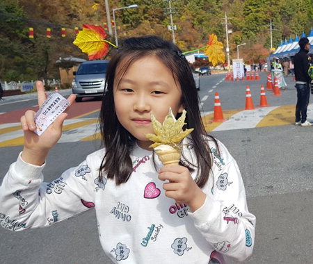 ▲ 태백 철암단풍축제장을 찾은 어린이가 단풍아이스크림을 맛보고 있다.