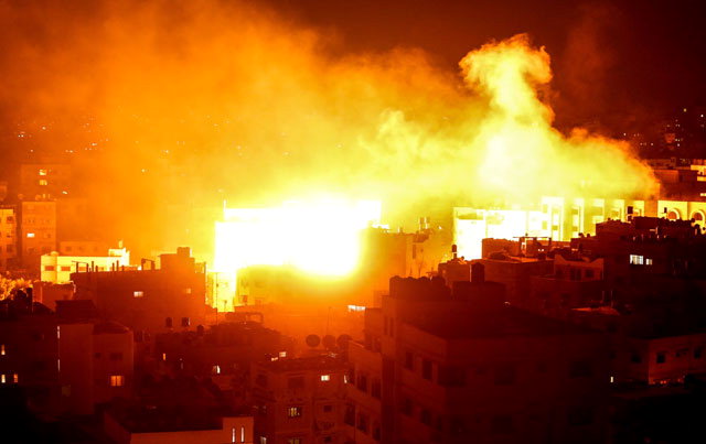 ▲ 가자지구에 대한 이스라엘군의 공습이 감행된 12일(현지시간) 팔레스타인 무장정파 하마스의 TV방송국 ‘알 아크사’ 본부 건물 위로 화염과 함께 연기가 치솟고 있다.