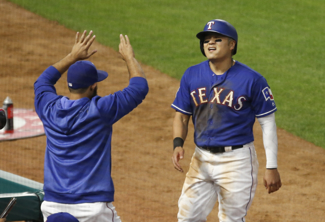 ▲ Apr 17, 2019; Arlington, TX, USA; Texas Rangers left fielder Shin-Soo Choo (right) celebrates with manager Chris Woodward (8)  after scoring against the Los Angeles Angels during the fifth inning at Globe Life Park in Arlington. Mandatory Credit: Jim Cowsert-USA TODAY Sports