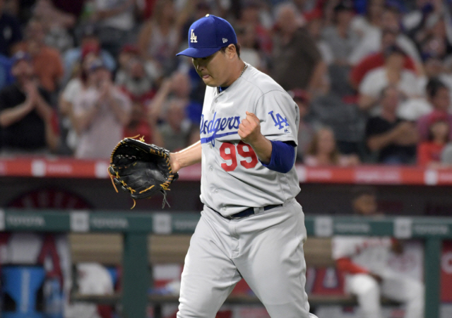 ▲ Jun 10, 2019; Anaheim, CA, USA; Los Angeles Dodgers starting pitcher Hyun-Jin Ryu (99) reacts after a striking out Los Angeles Angels center fielder Mike Trout (not pictured) to end the fifth inning at Angel Stadium of Anaheim. Mandatory Credit: Kirby Lee-USA TODAY Sports