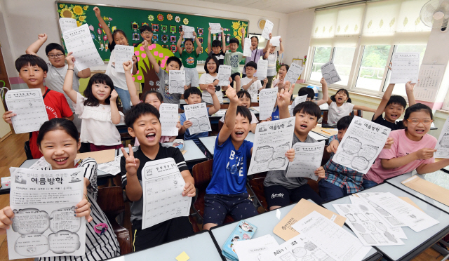 ▲ 18일 여름방학을 맞은 춘천 부안초교 3학년 어린이들이 방학 계획표를 들고 즐거워하고 있다.   최유진
