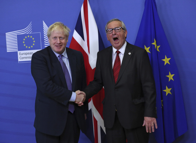 ▲ 보리스 존슨(왼쪽) 영국 총리와 유럽연합(EU) 행정부 수반 격인 장클로드 융커 집행위원장이 17일(현지시간) 벨기에 브뤼셀에서 열린 기자회견에서 악수를 하며 EU와 영국이 브렉시트(영국의 EU 탈퇴) 합의안 초안에 합의한 것을 기뻐하고 있다.