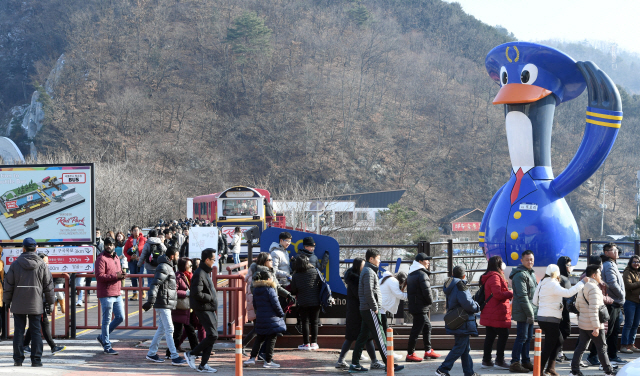 ▲ 미세먼지가 소강상태를 보인 15일 춘천 강촌유원지를 방문한 외국인 관광객들이 또오리 조형물 앞을 지나고 있다.   최유진