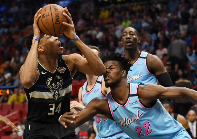 ▲ Mar 2, 2020; Miami, Florida, USA; Milwaukee Bucks forward Giannis Antetokounmpo (34) goes up for a shot against Miami Heat forward Jimmy Butler (22) in the first quarter at American Airlines Arena. Mandatory Credit: Jim Rassol-USA TODAY Sports
