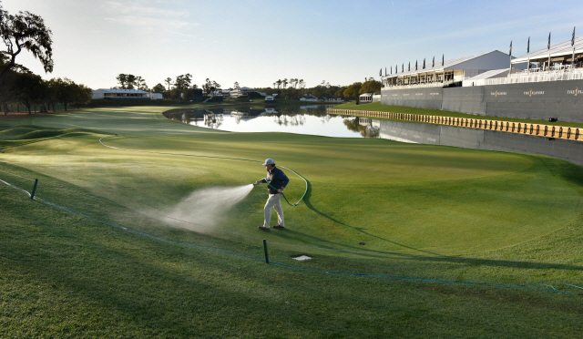 ▲ March 13, 2020; Ponte Vedra Beach, FL, USA; Assistant superintendent J. B. Workman waters the 18th green after the decision was made to cancel the last three days of The Players Championship because of the coronavirus Friday, March 13, 2020 in Ponte Vedra Beach, Florida.  Mandatory Credit: Will Dickey/Florida Times-Union via USA TODAY NETWOR