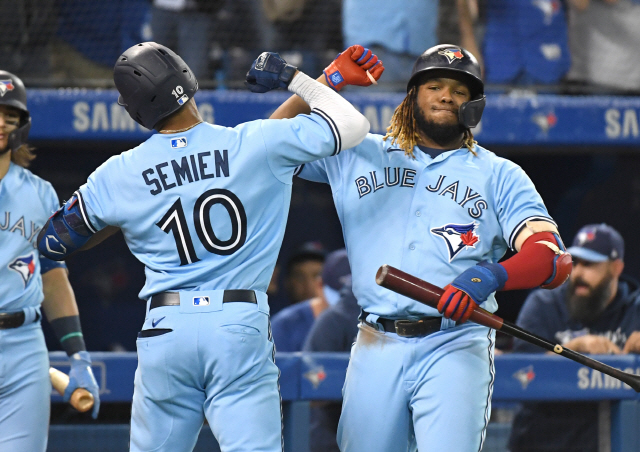 ▲ Oct 3, 2021; Toronto, Ontario, CAN;  Toronto Blue Jays second baseman Marcus Semien (10) is greeted by first baseman Vladimir Guererro Jr. (27) after hitting a solo home run against Baltimore Orioles in the fifth inning at Rogers Centre. Mandatory Credit: Dan Hamilton-USA TODAY Sports